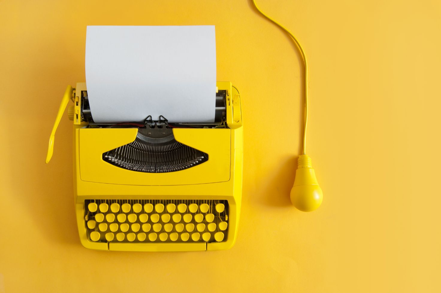 Yellow type writer and light bulb